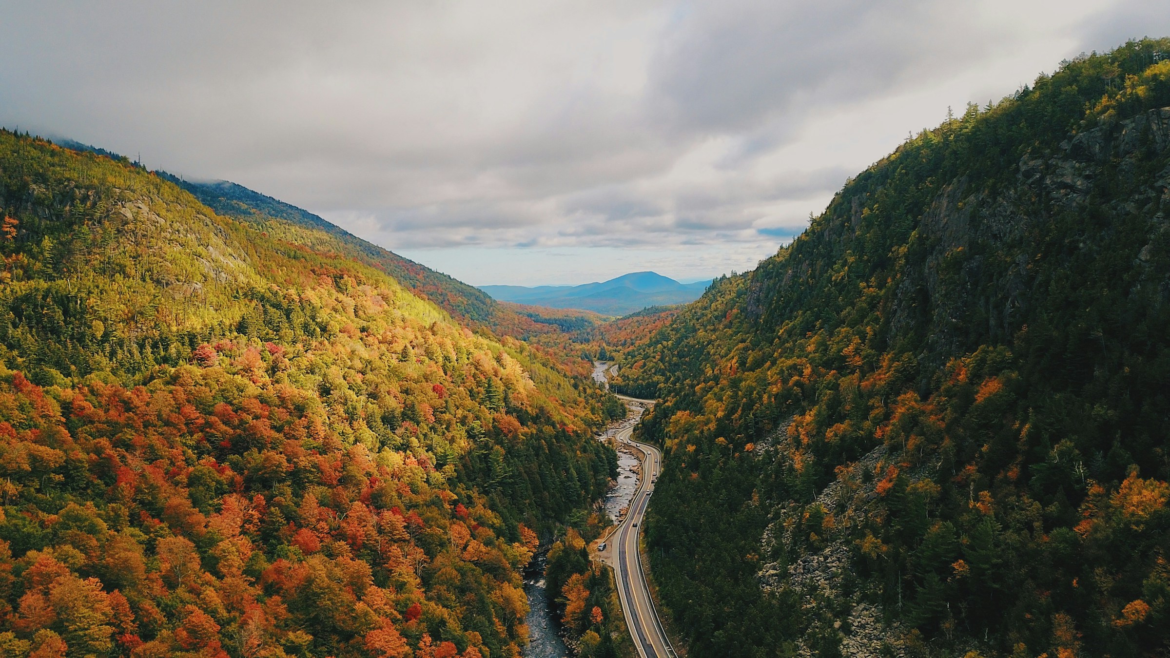 Aerial view of a road winding through autumn mountains